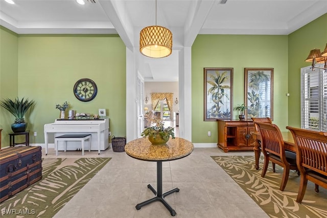 living area featuring beamed ceiling and light tile patterned floors