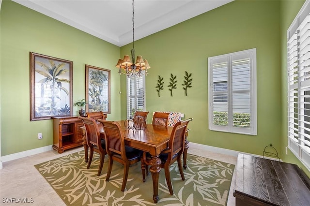 tiled dining space with an inviting chandelier