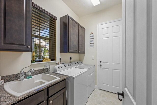 laundry room with cabinets, independent washer and dryer, sink, and light tile patterned floors