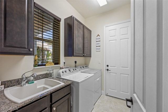 clothes washing area featuring washing machine and clothes dryer, a sink, cabinet space, and baseboards