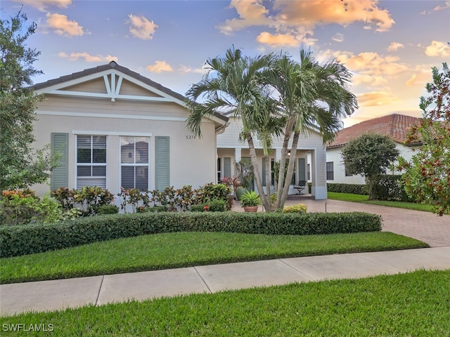 view of front of property with stucco siding and a front yard