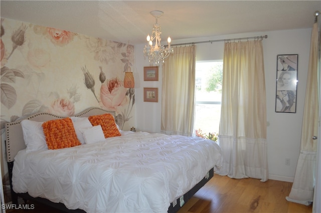 bedroom featuring a chandelier and hardwood / wood-style floors