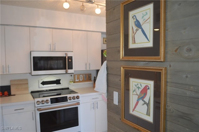 kitchen with white cabinets and high end stainless steel range