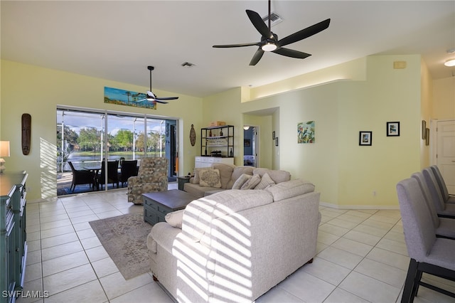 tiled living room with ceiling fan