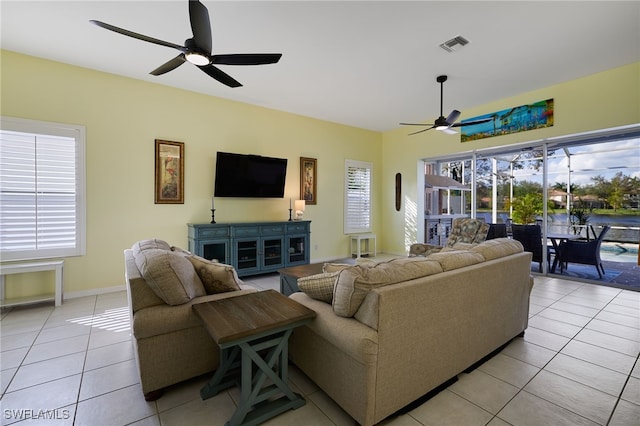 living room featuring ceiling fan and light tile patterned flooring