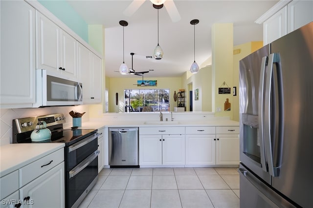 kitchen with white cabinetry, sink, ceiling fan, light tile patterned floors, and appliances with stainless steel finishes