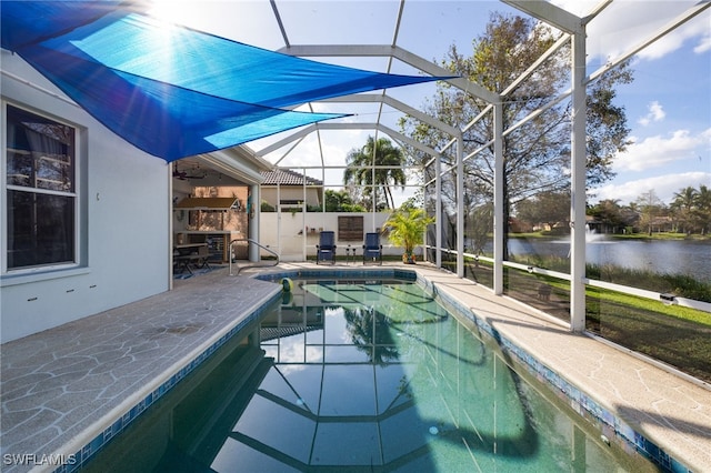 view of pool with a patio, a water view, and a lanai