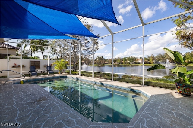 view of pool featuring a lanai, a patio area, and a water view