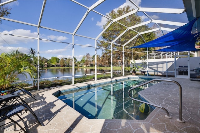 view of pool with a patio area, a water view, and glass enclosure