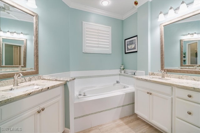 bathroom with a washtub, vanity, and ornamental molding