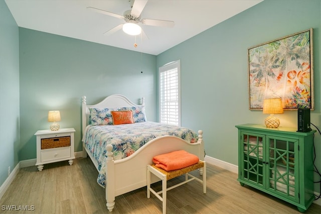 bedroom with hardwood / wood-style floors and ceiling fan