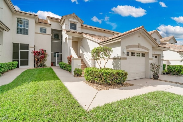 view of front of property featuring a front yard and a garage