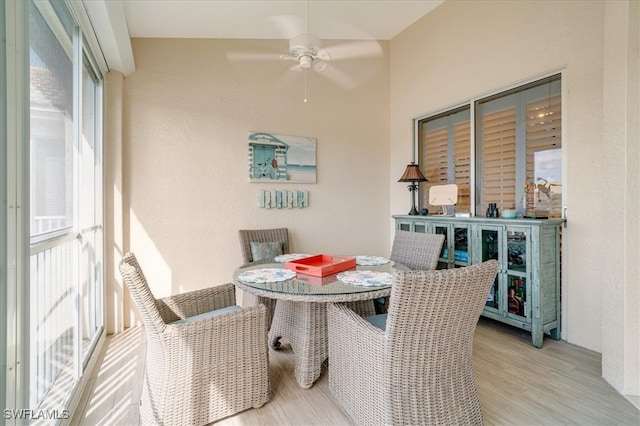 sunroom / solarium featuring ceiling fan