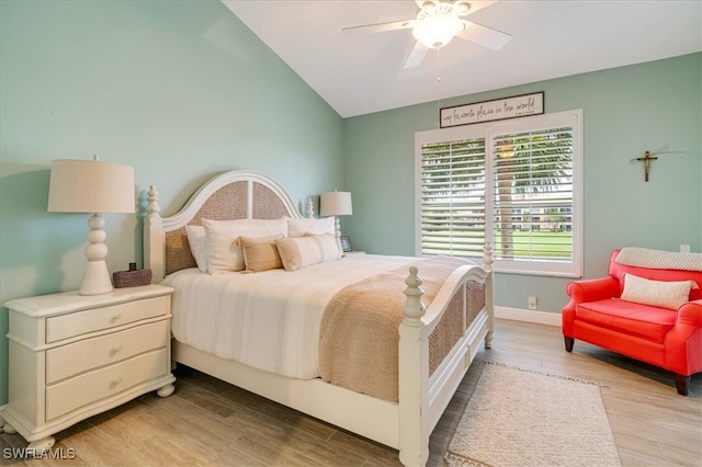 bedroom featuring ceiling fan, light hardwood / wood-style flooring, and vaulted ceiling