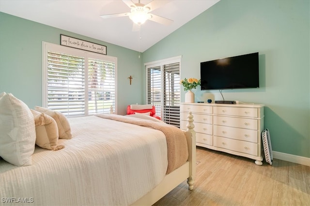 bedroom with vaulted ceiling, light hardwood / wood-style flooring, and ceiling fan