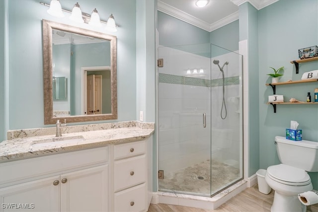 bathroom with toilet, hardwood / wood-style flooring, vanity, a shower with shower door, and ornamental molding