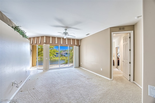 carpeted empty room featuring ceiling fan