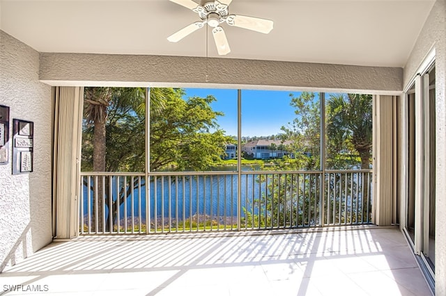 unfurnished sunroom featuring ceiling fan