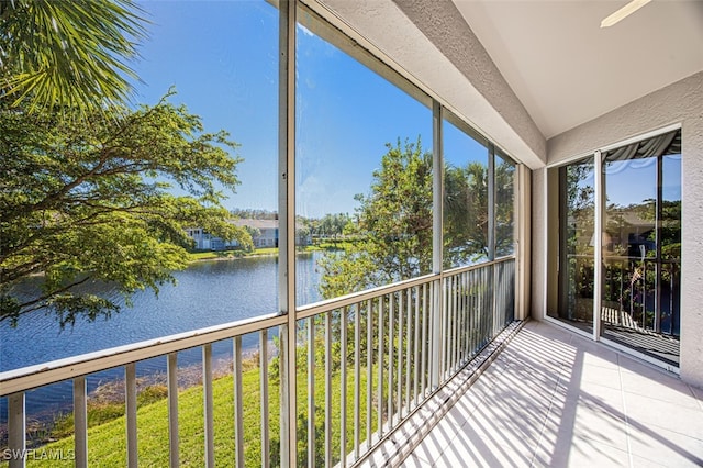 unfurnished sunroom featuring a water view