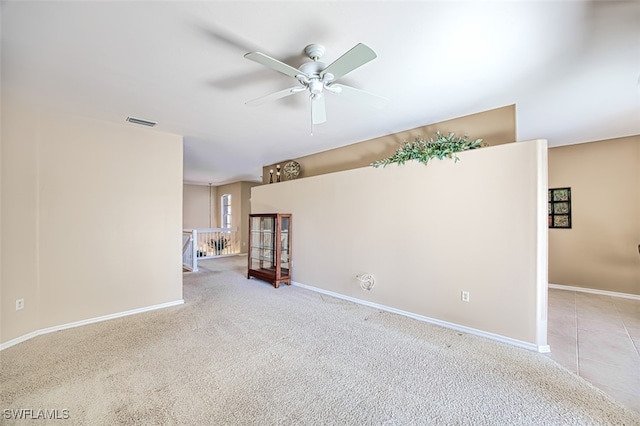 unfurnished room featuring light carpet and ceiling fan