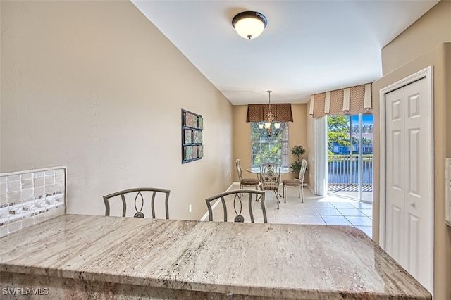 tiled dining room with a notable chandelier