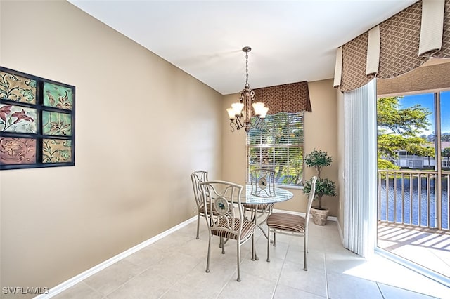 tiled dining space with an inviting chandelier