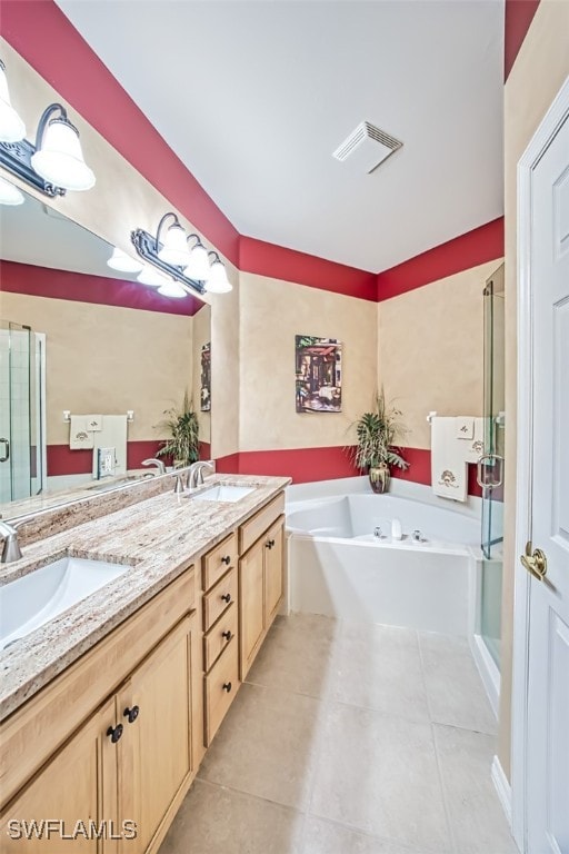 bathroom with tile patterned floors, vanity, and separate shower and tub