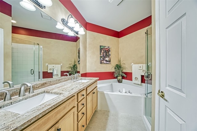 bathroom featuring tile patterned flooring, vanity, and shower with separate bathtub