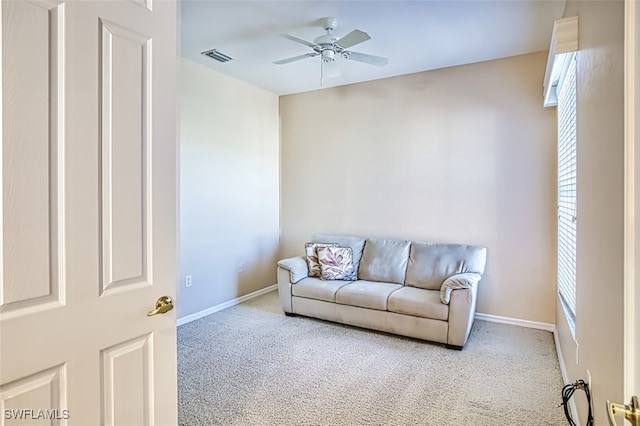 living room with ceiling fan and carpet floors