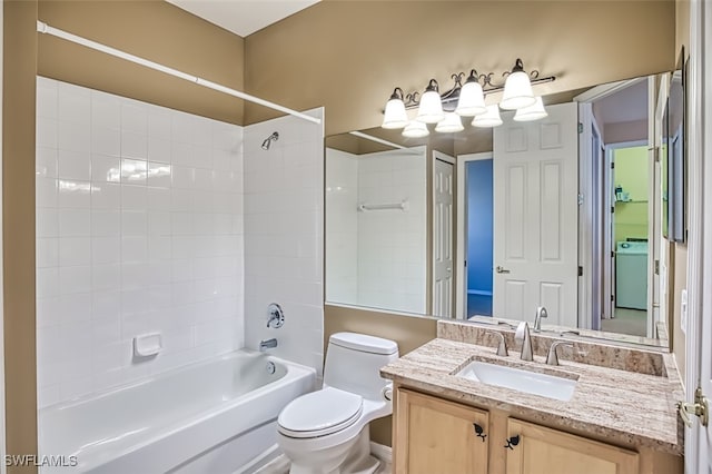 full bathroom with washer / dryer, vanity, toilet, and tiled shower / bath