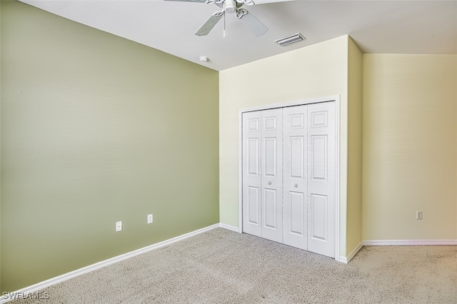 unfurnished bedroom featuring ceiling fan, carpet floors, and a closet