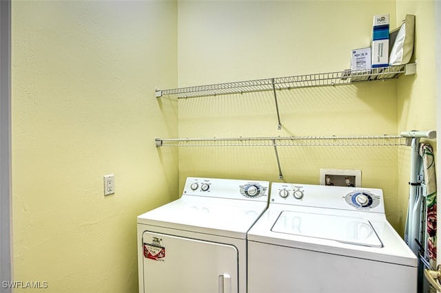 washroom featuring washer and clothes dryer