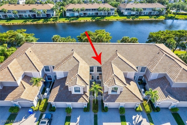 birds eye view of property featuring a water view