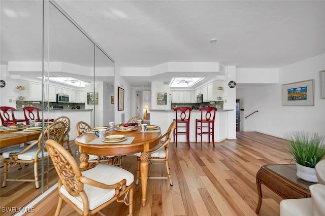 dining room with light wood-type flooring