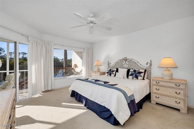 carpeted bedroom featuring access to exterior and ceiling fan