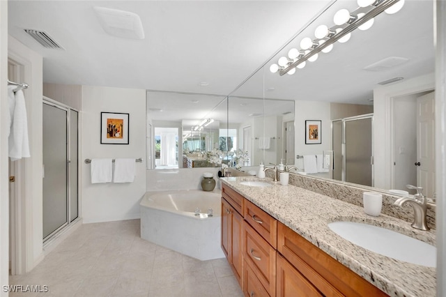 bathroom with tile patterned floors, vanity, and shower with separate bathtub