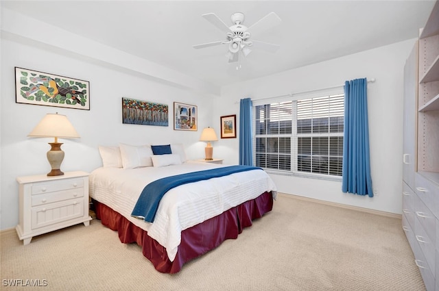 bedroom featuring light colored carpet and ceiling fan