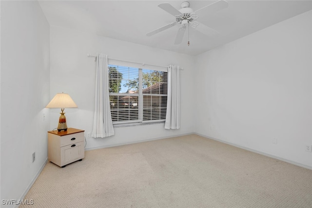 unfurnished room featuring light carpet and ceiling fan