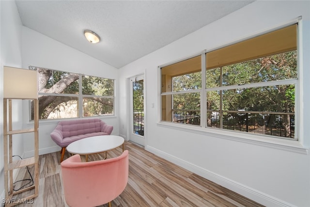 sunroom featuring lofted ceiling