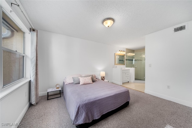 carpeted bedroom featuring a textured ceiling