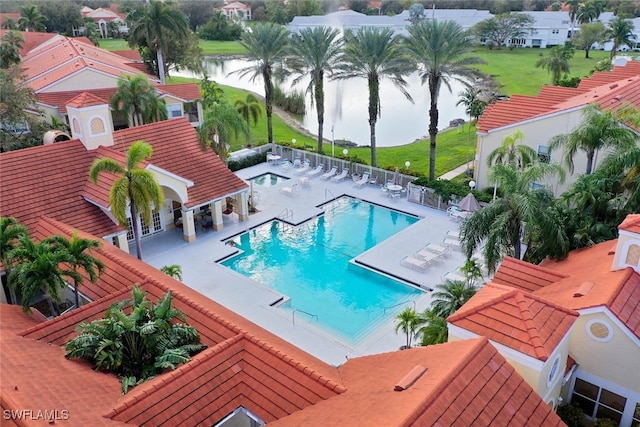 view of swimming pool with a patio area and a water view