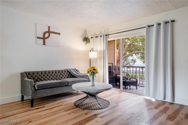 sitting room with hardwood / wood-style flooring and a textured ceiling