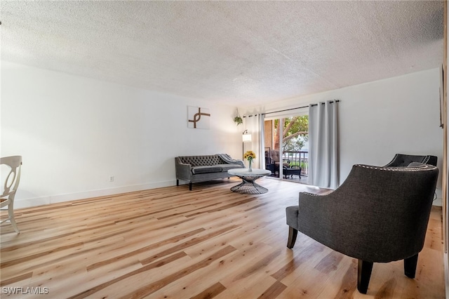 sitting room featuring light hardwood / wood-style floors and a textured ceiling