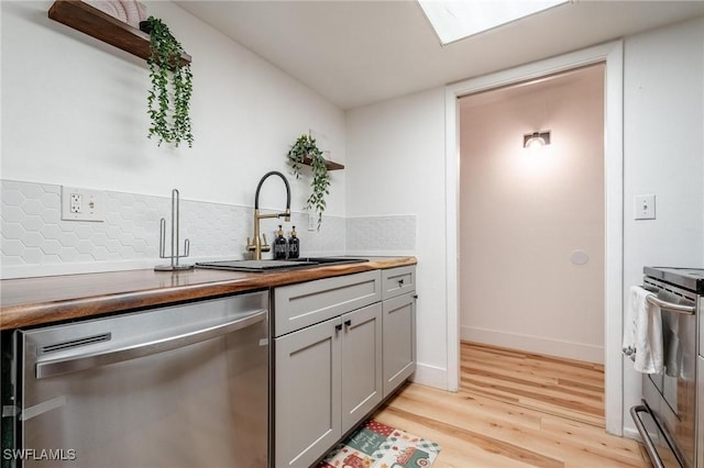 2366 E Mall Dr Unit 211, Fort Myers, FL 33901 - kitchen featuring stainless steel appliances, light wood-type flooring, a sink, butcher block countertops, and gray cabinetry
