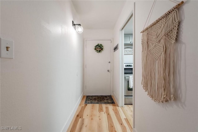 hallway with light hardwood / wood-style flooring