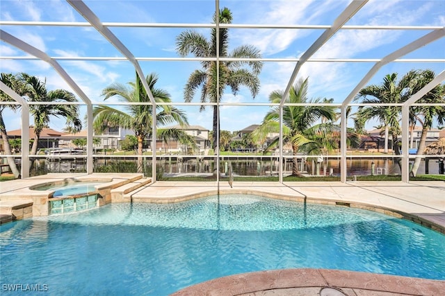 view of pool with a lanai, a patio area, an in ground hot tub, and a water view