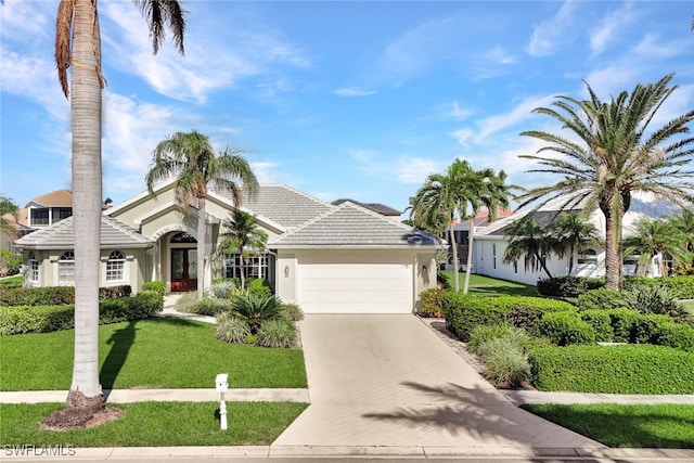 view of front of house featuring a front yard and a garage