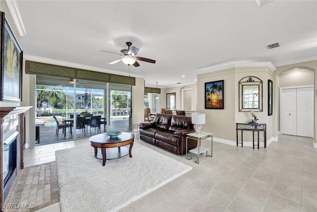 living room featuring light tile patterned floors, plenty of natural light, crown molding, and ceiling fan