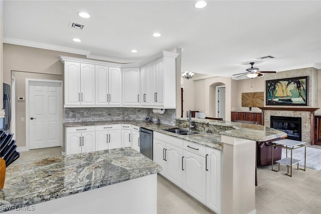 kitchen featuring kitchen peninsula, white cabinetry, sink, and dishwasher