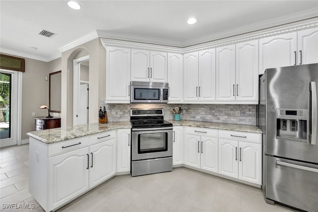 kitchen featuring white cabinetry, stainless steel appliances, backsplash, kitchen peninsula, and ornamental molding